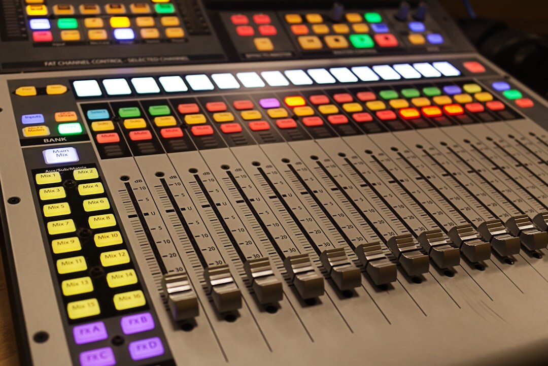Close-up of a broadcast video switcher panel with illuminated tally lights