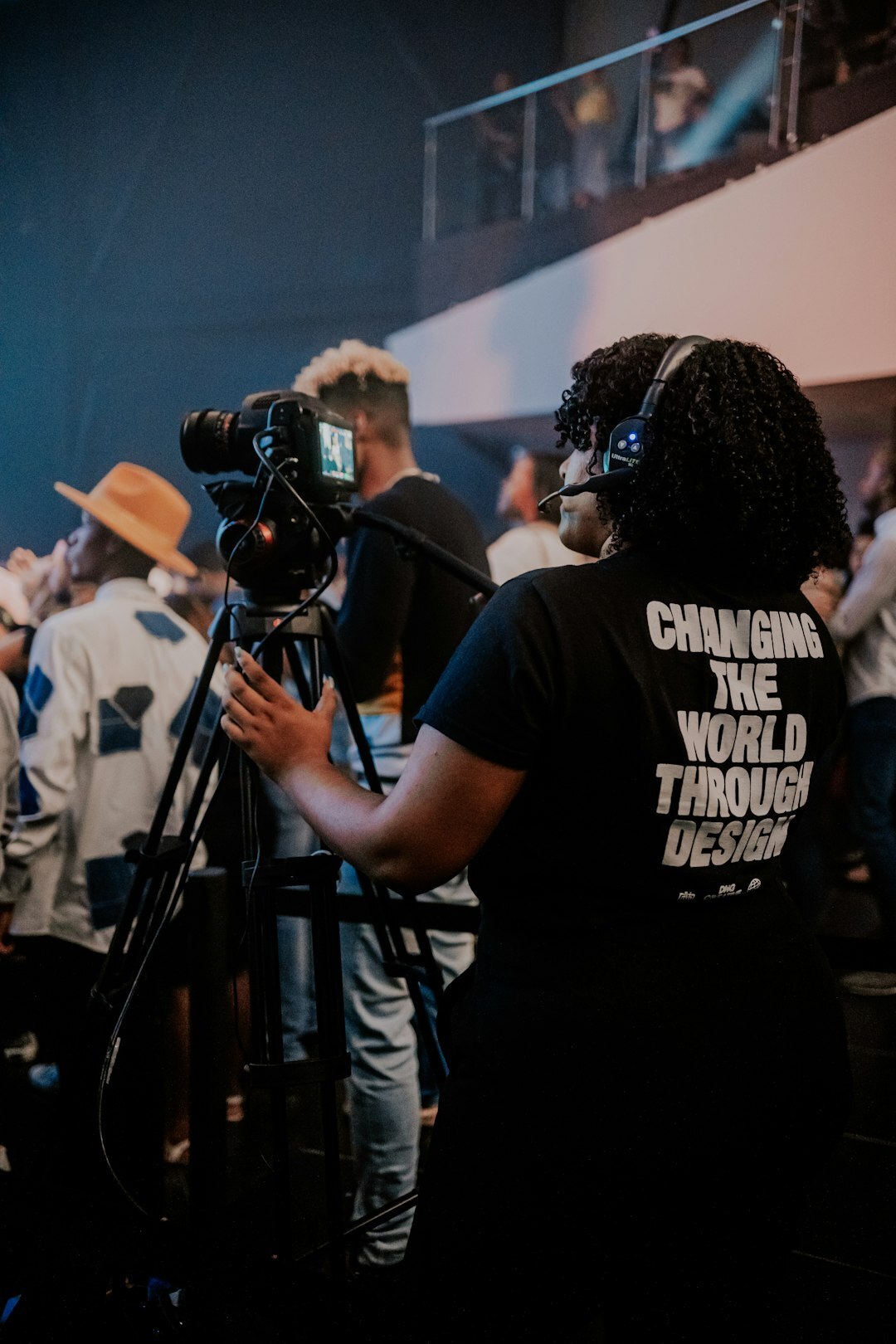 Producer wearing a headset directing a broadcast crew in a control room