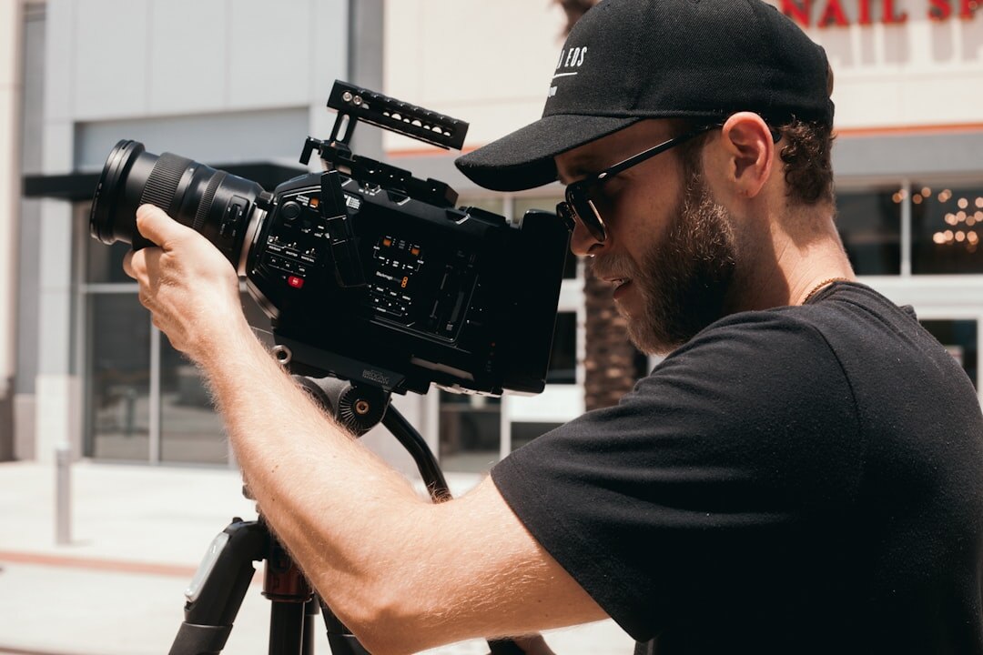 Camera operator filming with a professional broadcast camera in a TV studio